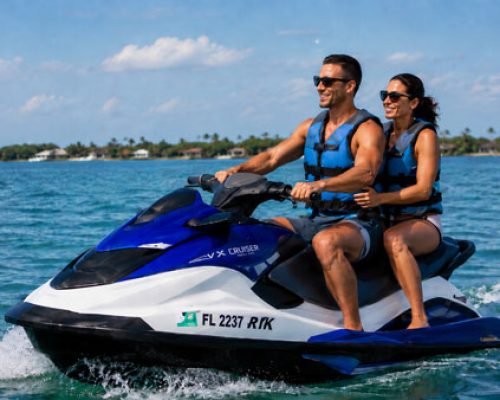 A male and female couple riding a jet ski near Manasota Key.